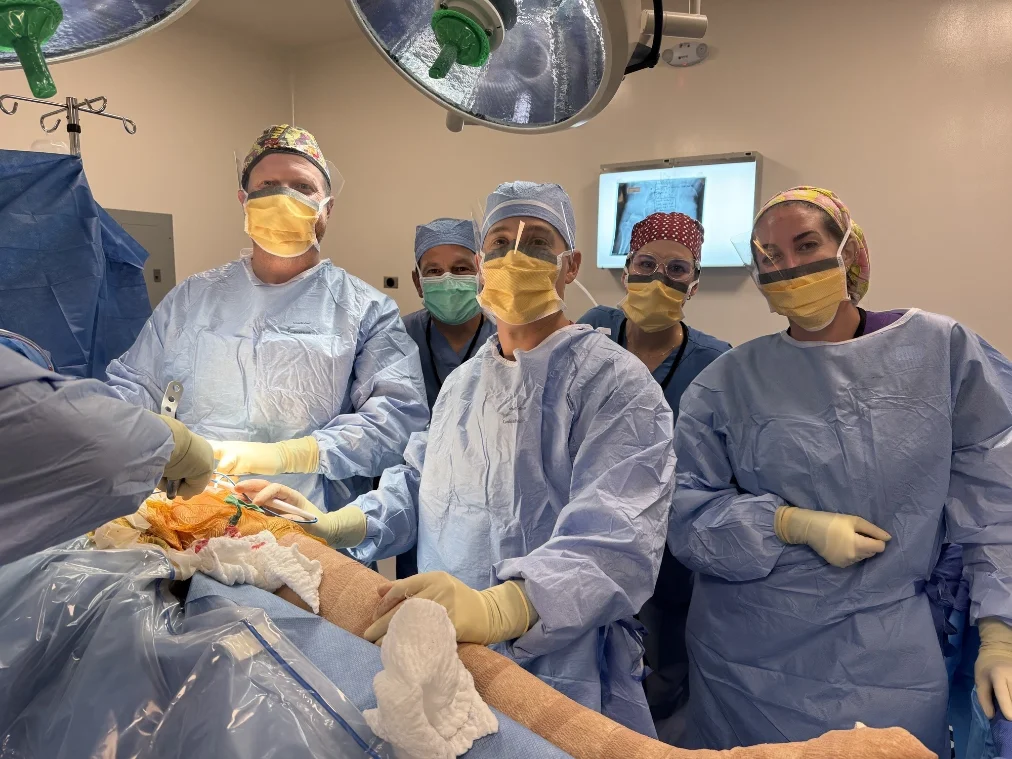 The Operation Walk surgical team in gowns and masks in the operating room.