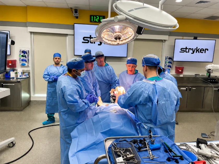 Dr. Grosso teaching a group of surgeons at a Stryker robotic surgery training lab.
